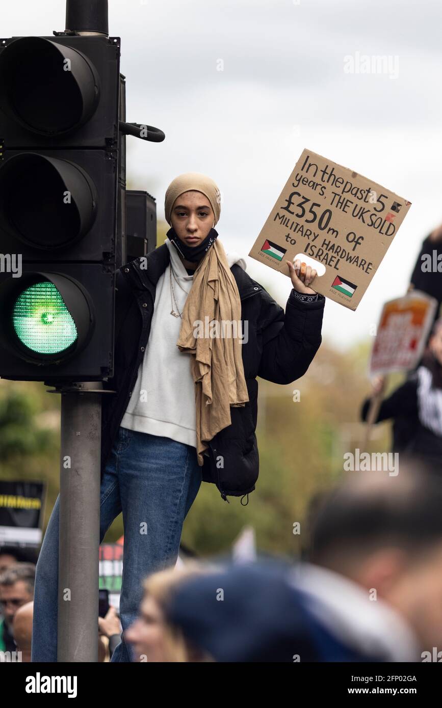 Protester with placard standing on traffic lights, 'Free Palestine' solidarity protest, London, 15 May 2021 Stock Photo