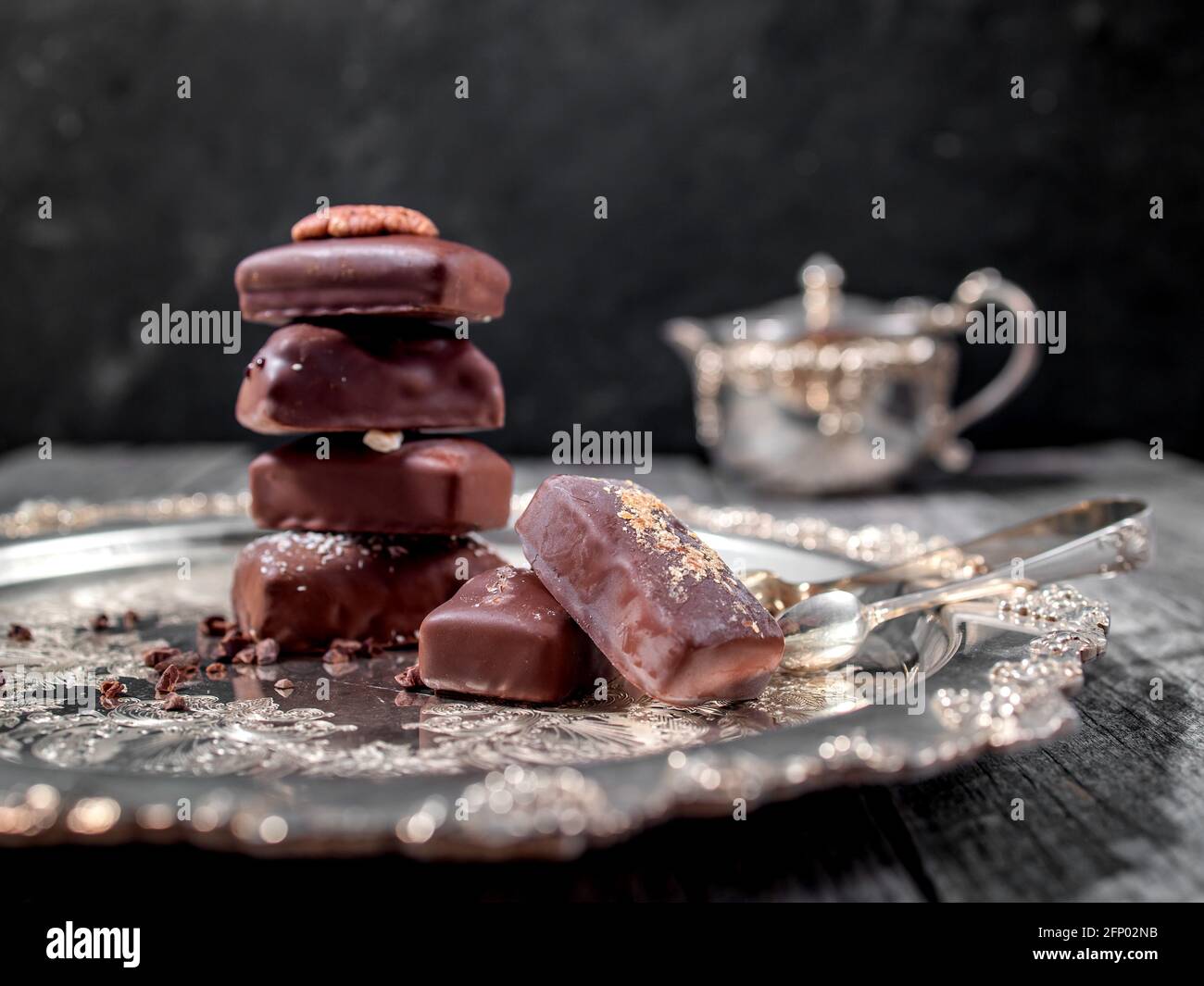 Dark handmade chocolate stack with cacao chips and nuts Stock Photo