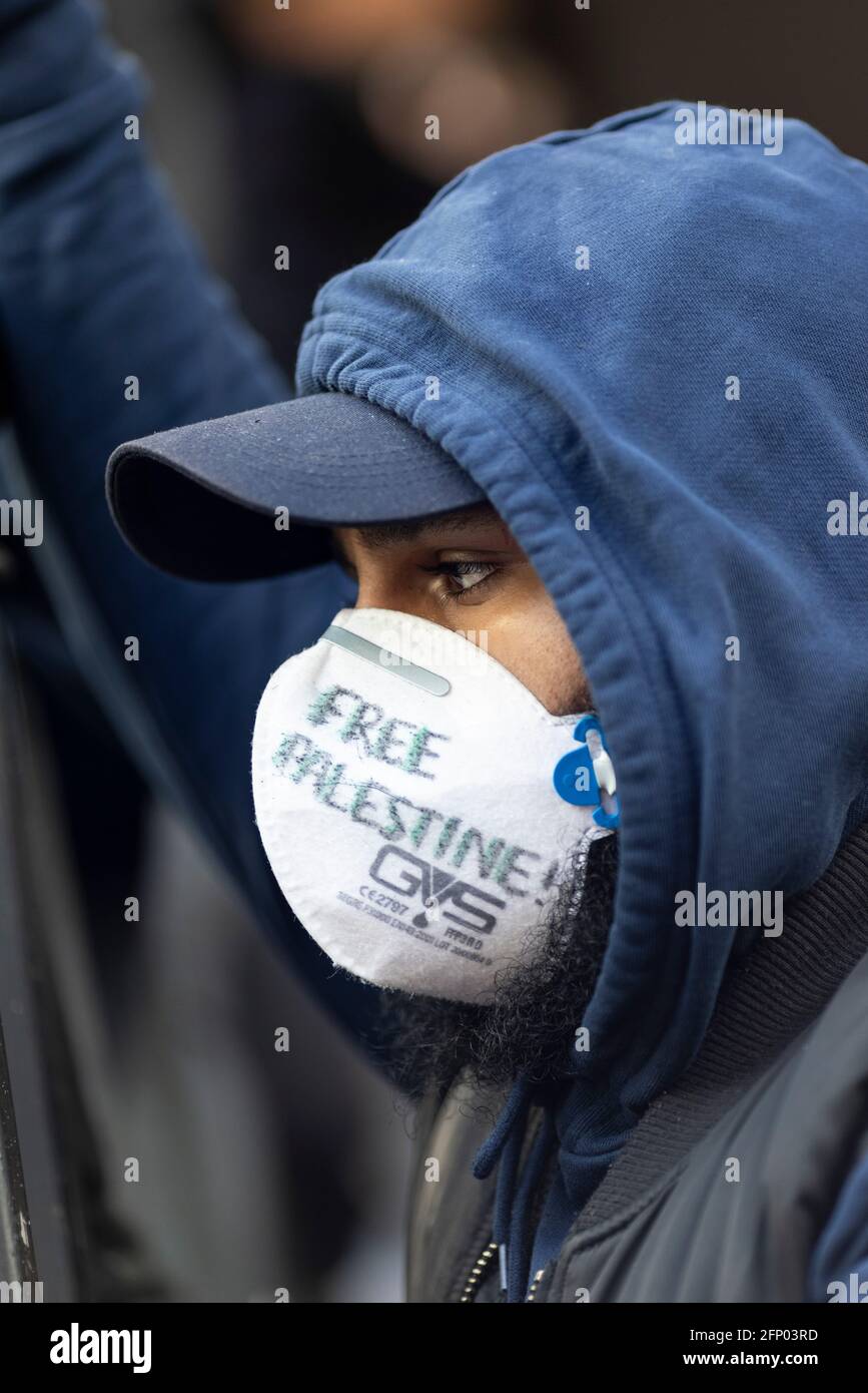 Profile portrait of protester in face mask, 'Free Palestine' solidarity protest, London, 15 May 2021 Stock Photo