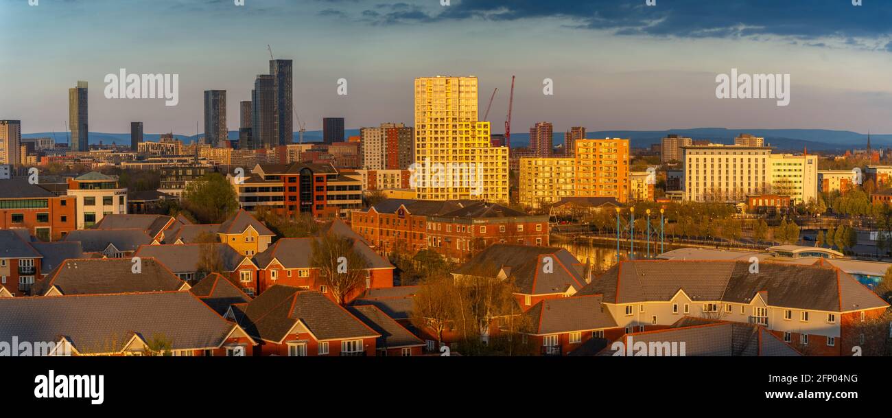 View of Manchester skyline and rooftops at sunset from Salford Quays, Manchester, England, United Kingdom, Europe Stock Photo