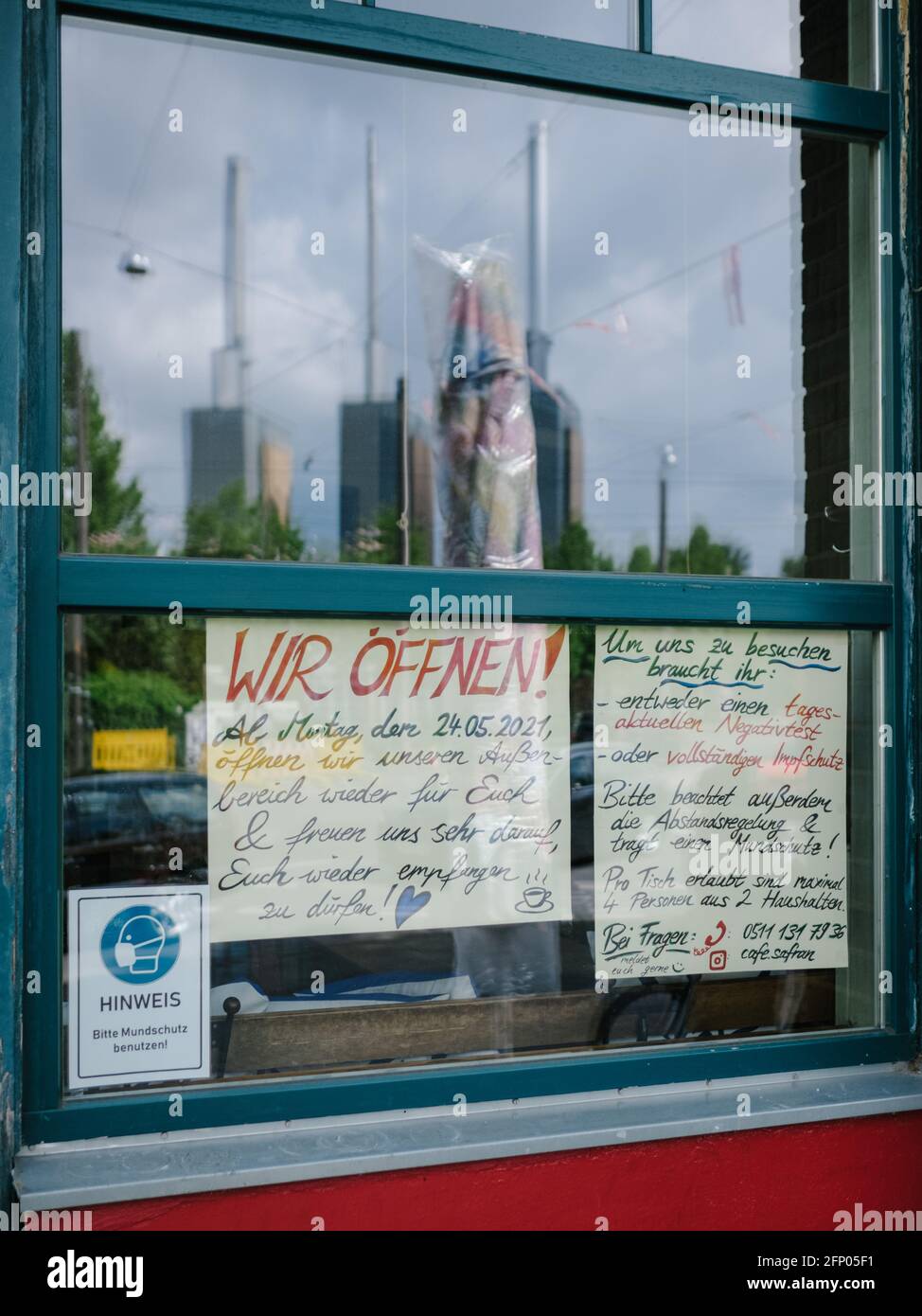 Hanover, Germany. 20th May, 2021. 'We open' is written on a cafe in the Calenberger Neustadt. Due to falling corona incidence values, the region of Hanover is relaxing its corona regulations. Credit: Ole Spata/dpa/Alamy Live News Stock Photo