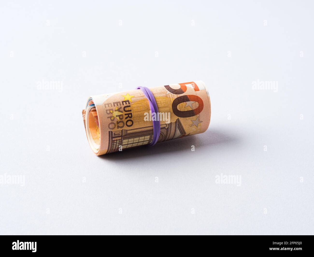 Euro 50 value banknotes roll with rubber on gray background Stock Photo ...