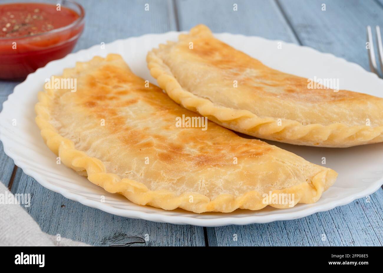 Fried pies with meat on a plate, side view Stock Photo