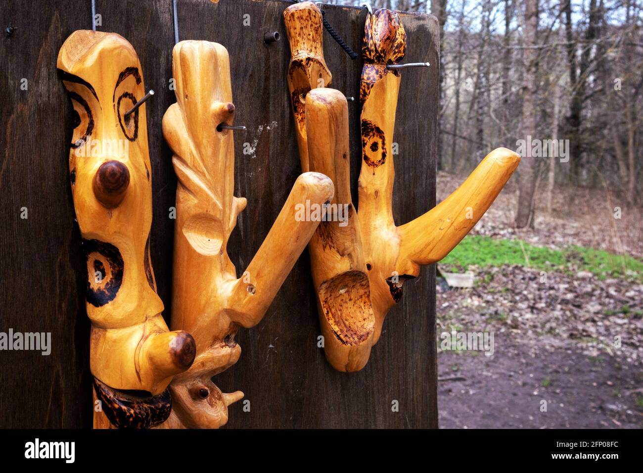 Decorative hanger, fancifully carved polished handcrafted tree knots at the open air fair Stock Photo