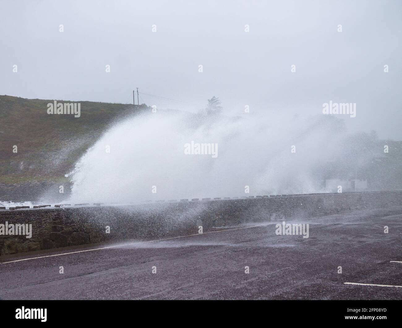 Tragumna, West Cork, Ireland, Thursday 20th  May 2021. Storm force winds overnight and today with speeds up to 110kph sent huge waves battering the sea defence wall along the coast road at Tragumna,West Cork today. Credit aphperspective/ Alamy Live News Stock Photo