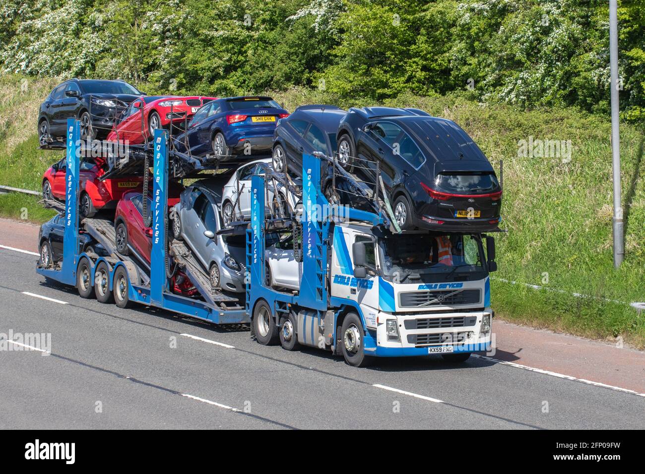 Mobile Services Auto transporter, car transporter carrier; Motorway heavy bulk Haulage delivery trucks, haulage, lorry, transportation, collection and deliveries, multi-car commercial vehicle carrier, truck, special cargo, vehicle, delivery, transport, industry, freight on the M6 motorway. Stock Photo