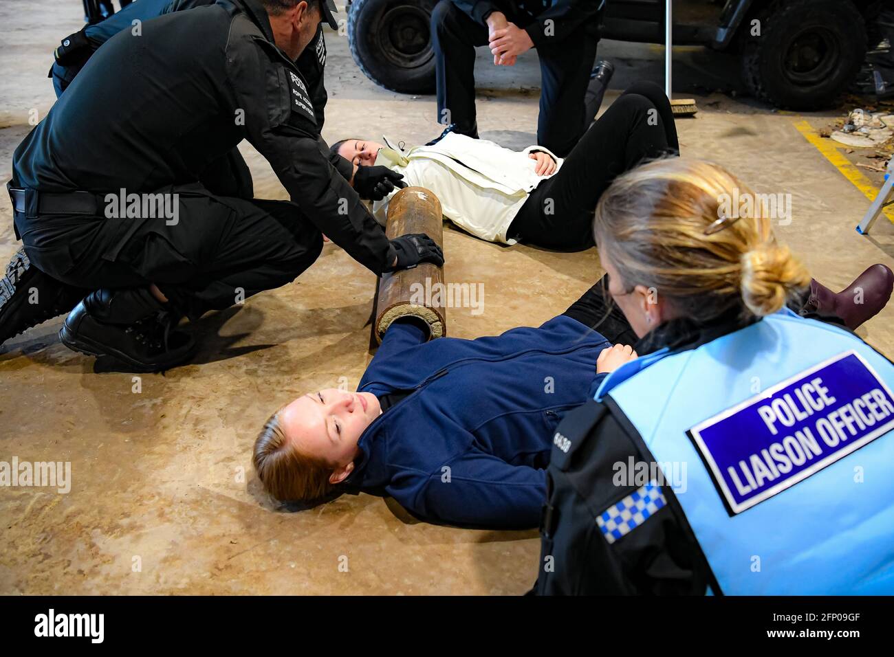 Members of Devon and Cornwall Police Protestor Removal Team and Police Liaison Officers respond to a 'lock-on' training scenario at the force headquarters in Exeter, where they are preparing for the forthcoming G7 Summit in Cornwall. The 'lock-on' tube, often made of plastic, steel and concrete, are used by protestors to lock arms together while causing obstructions or blocking roads and have to be carefully cut free by police after appealing to the protesters to relent their protest. Picture date: Thursday May 20, 2021. Stock Photo