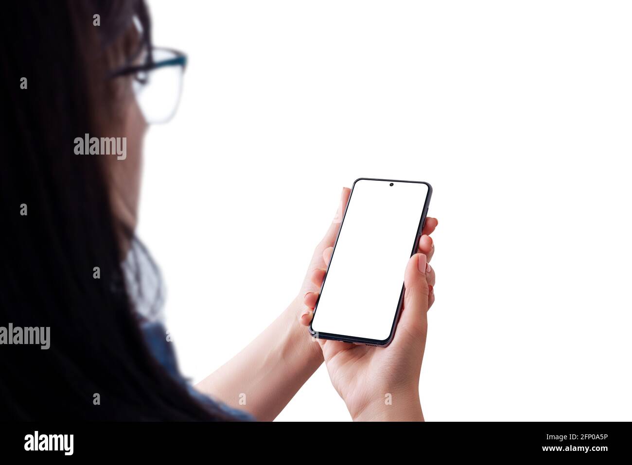 Woman holding smart phone with isolated screen for mockup, app interface presentation. Over the shoulder view Stock Photo