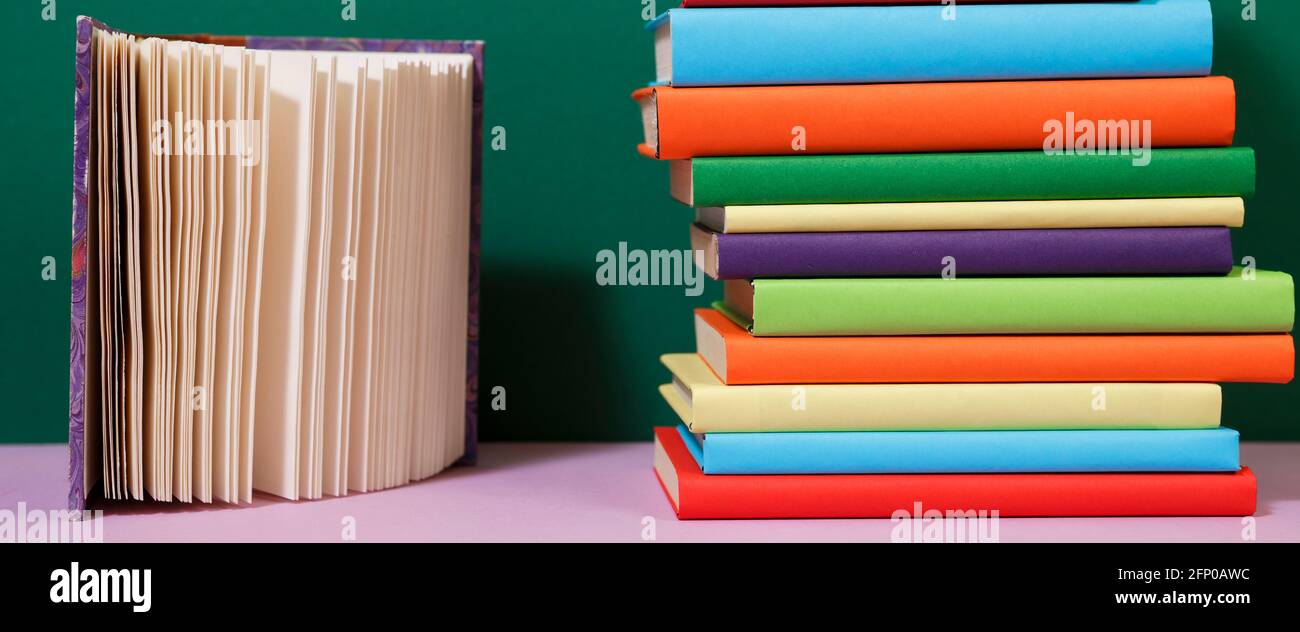 Composition with vintage old hardback books, colored background. Books stacking. Back to school. Copy Space. Education background. Stock Photo