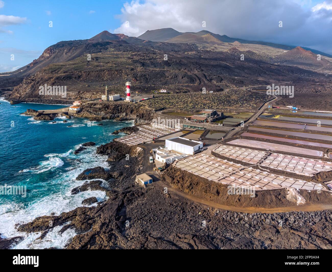 Volcanic landscape with lighthouse and salt production facility. La Palma island, aerial view. Stock Photo