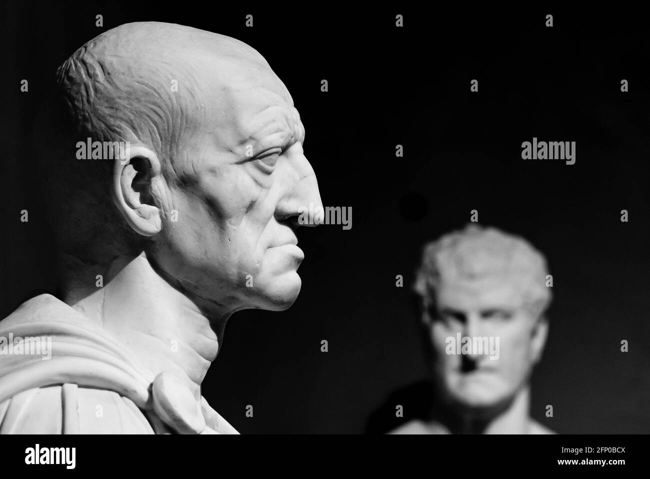 Black and white photo of ancient sculptures of roman men in close-up Stock Photo