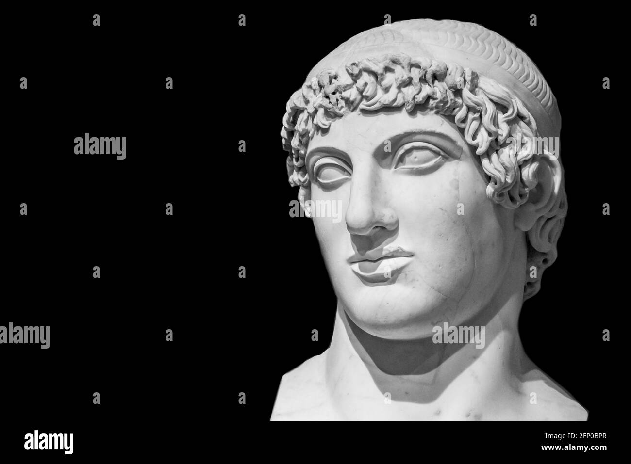 Black and white photo of ancient roman statue statue in close-up showing the handsome face of a young man Stock Photo