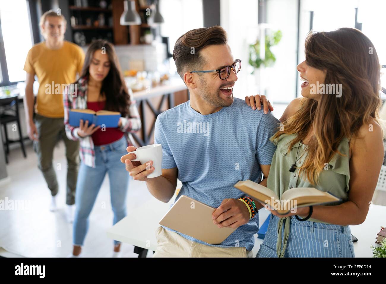 Happy group of young students studying together Stock Photo - Alamy