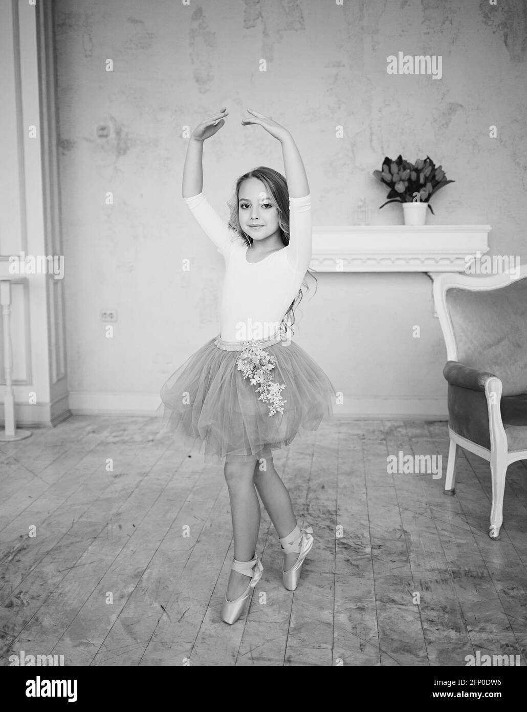 cute little ballerina girl dancing looking at the camera Stock Photo
