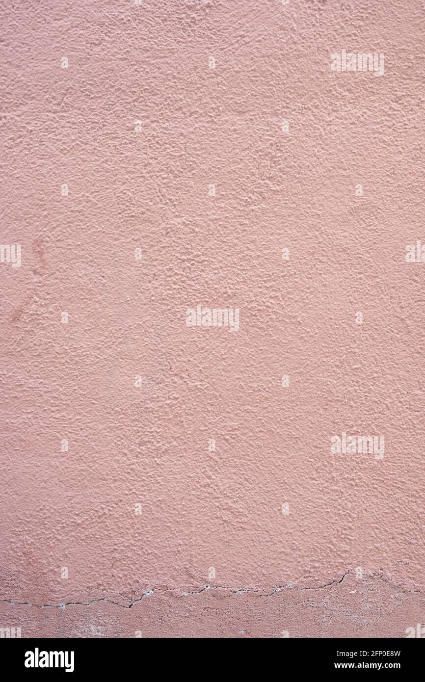 Horizontal photograph of the texture of a light reddish cement wall. Stock Photo