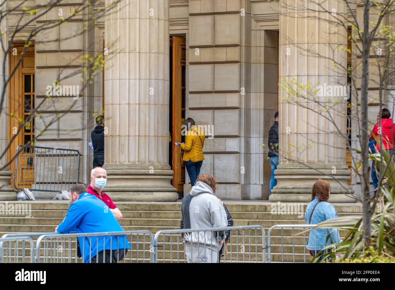 Members of the public queue at a mass NHS Tayside covid-19 vaccination centre, at the Caird Hall, City Square, Dundee, Tayside, Scotland. Stock Photo