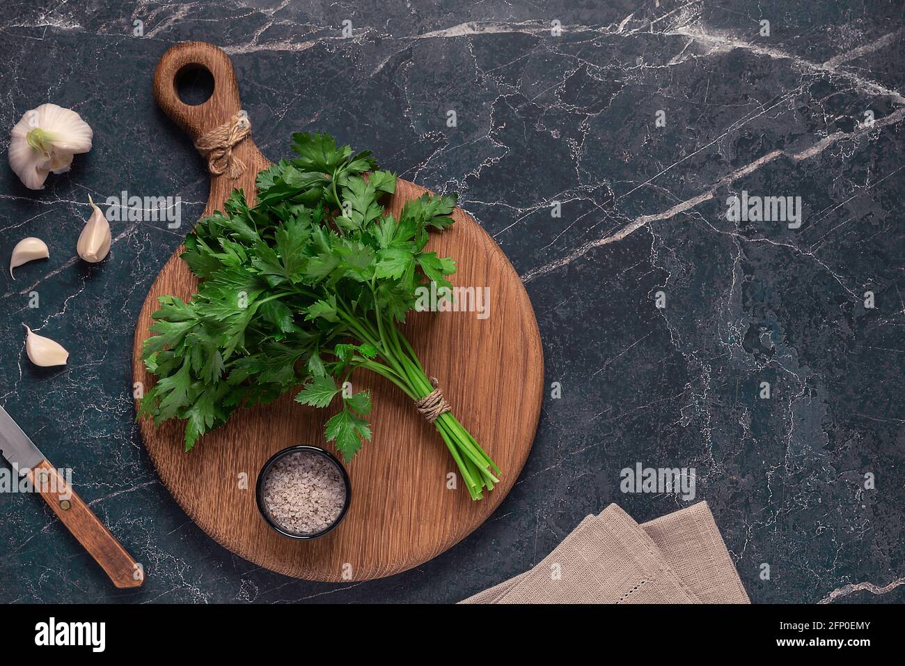cutting board, parsley on a marble table, top view Stock Photo