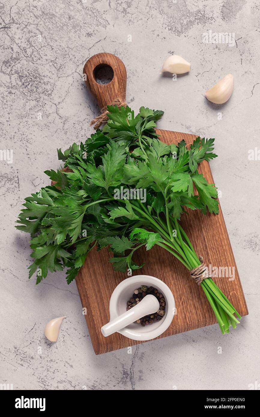 cutting board, parsley on a concrete table, top view Stock Photo