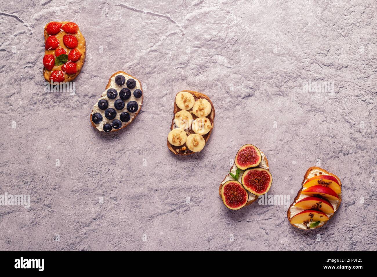 Homemade summer toast with cream cheese, nut butter and fruits and