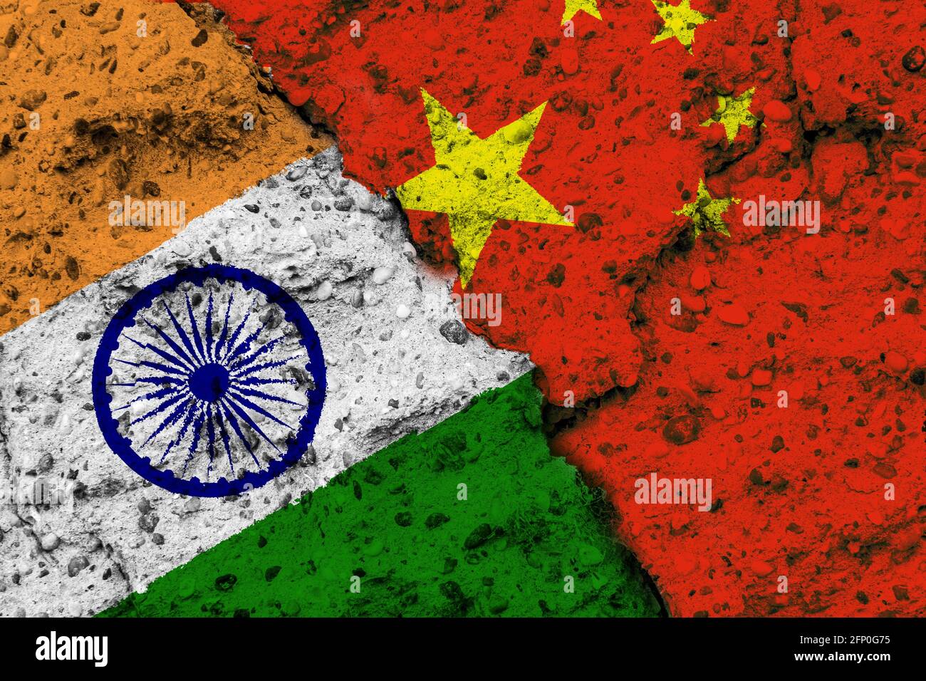 Concept of the conflictual Relations between India and China by Flags on a rough Wall with a Crack Stock Photo