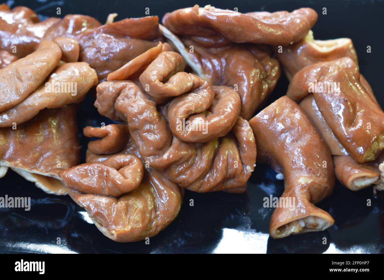 grilled slice pork intestine on plate dipping spicy sauce Stock Photo