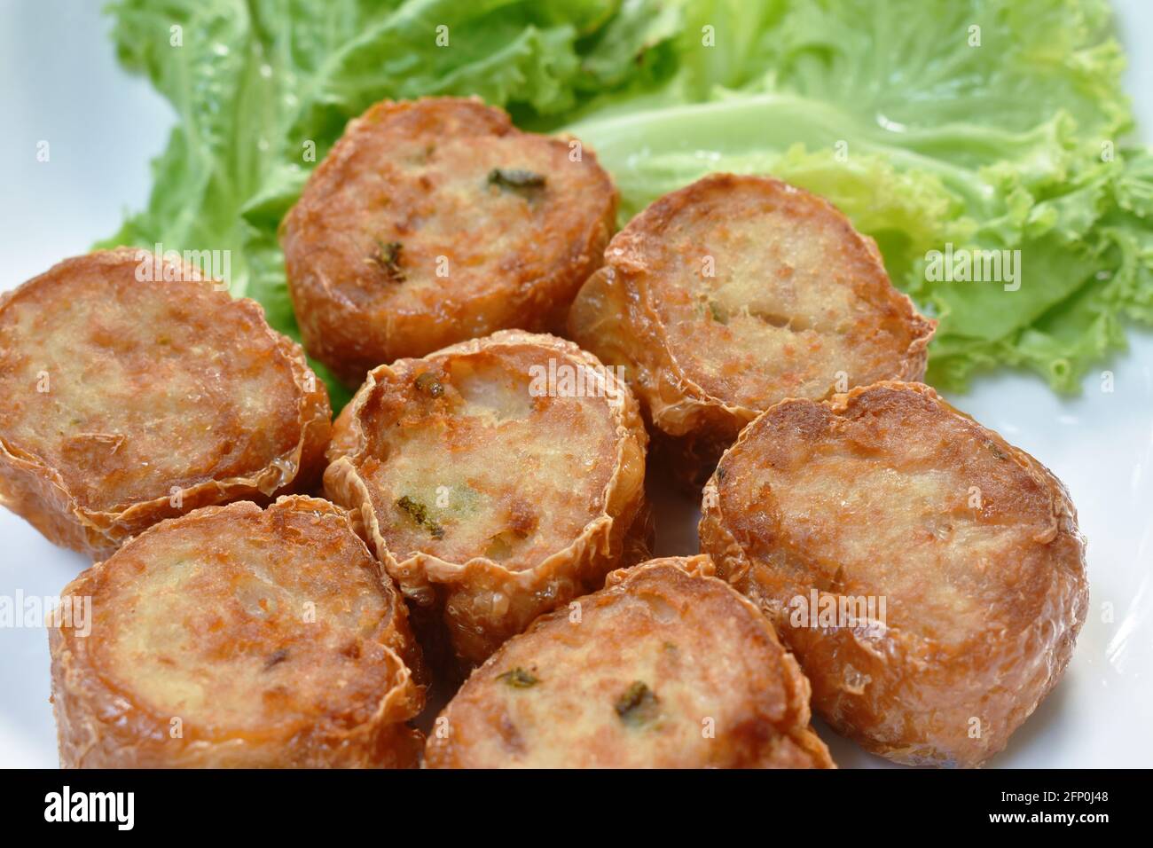 deep fried mashed crab meat and pork roll Chinese food on plate dipping