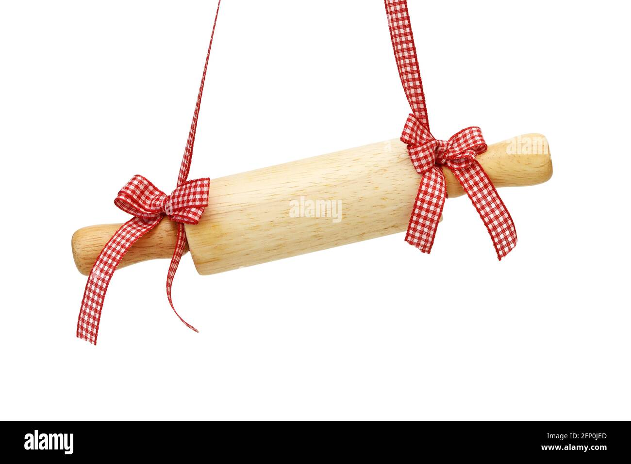 rolling pin hangs in front of white background Stock Photo