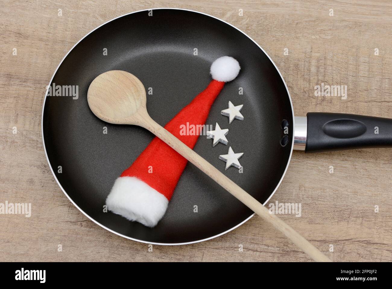 wooden spoon and santa hat in frying pan Stock Photo