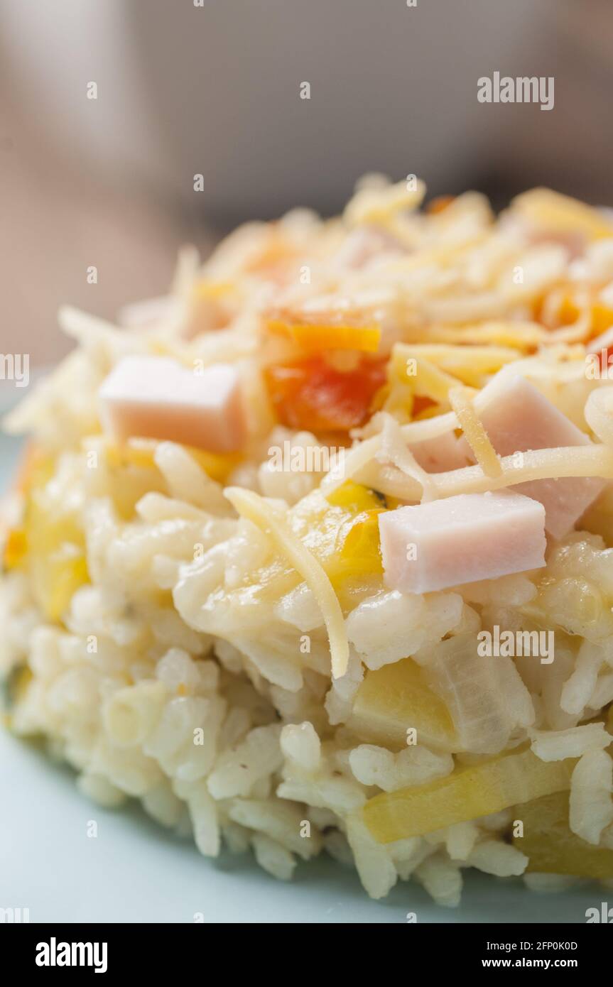 Vertical closeup shot of sticky rice with carrots, zucchini cooked ham ...