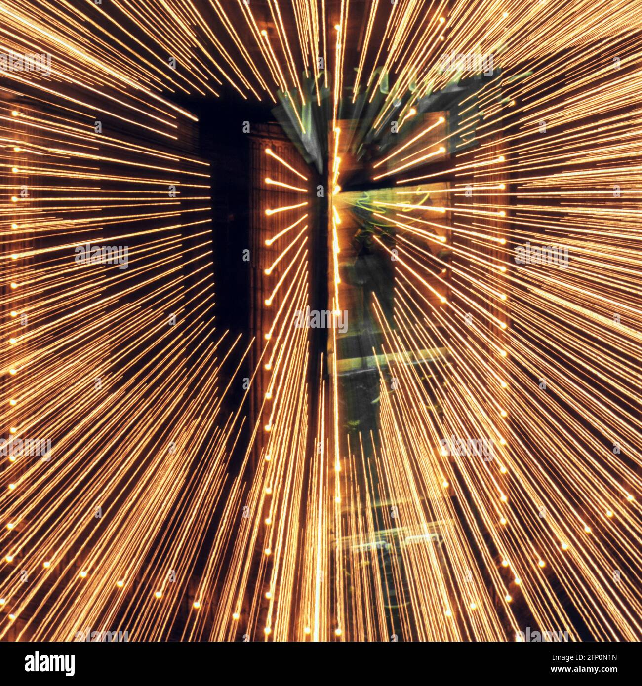 Abstract & background image camera lens zoomed technique on night time exposure of shop front lighting display creating radiating straight lines UK Stock Photo