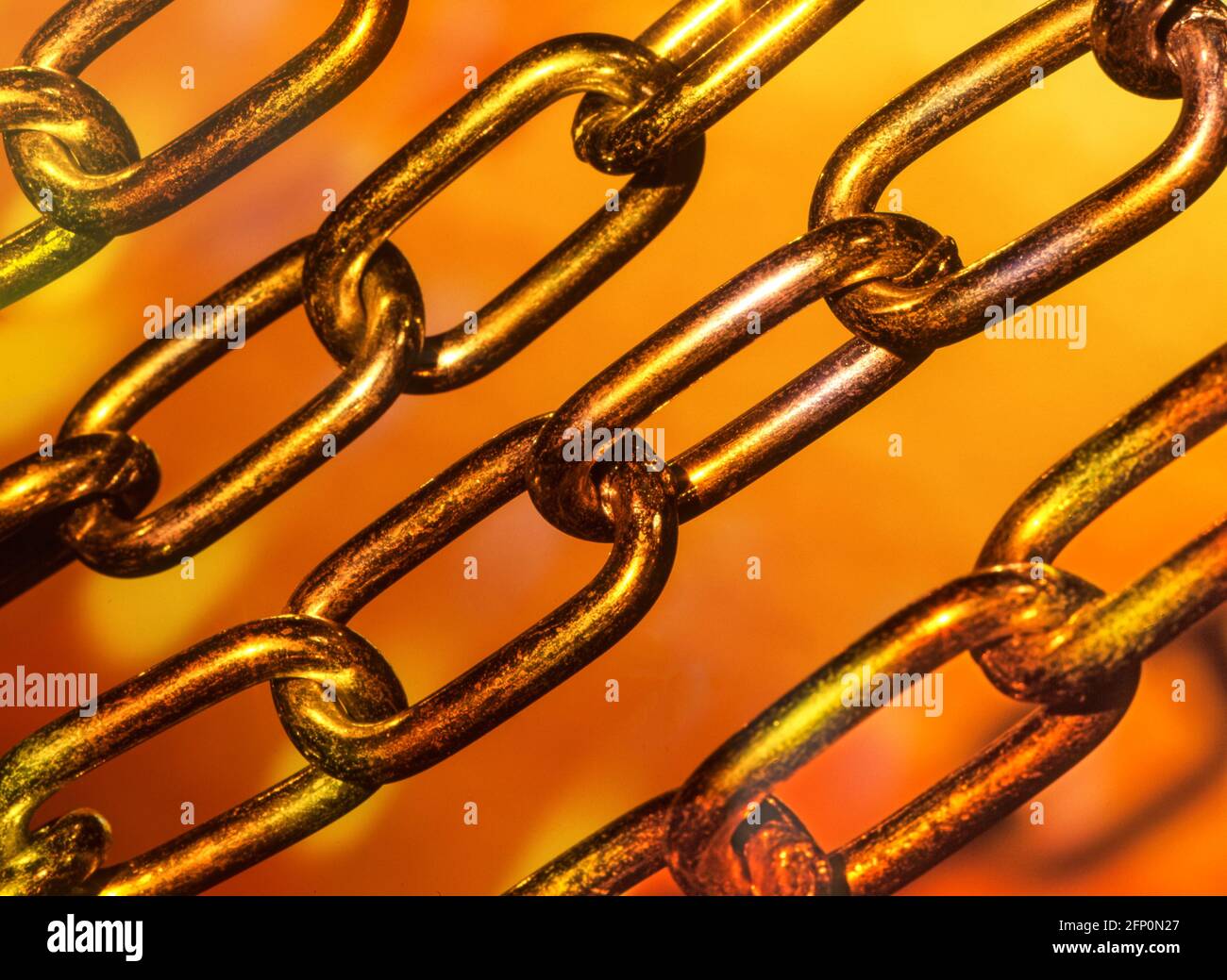 Colourful close up concept image of strong steel chain links joined up together in a metal