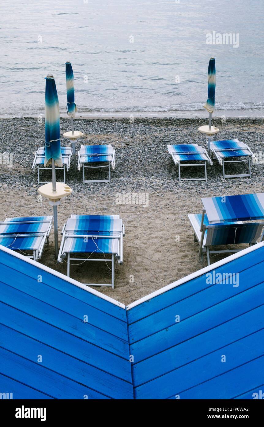 high angle view of a deserted beach with sunbeds, parasols and beach huts, Riviera di Ponente, Liguria, Italy Stock Photo