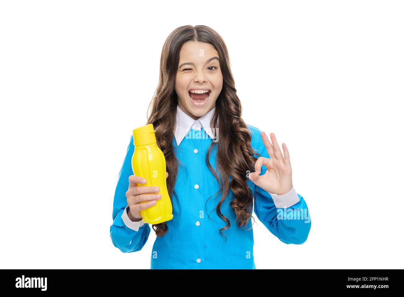 Drink it up. Playful child show OK sign holding plastic bottle. Beverage product. Beverage packaging Stock Photo