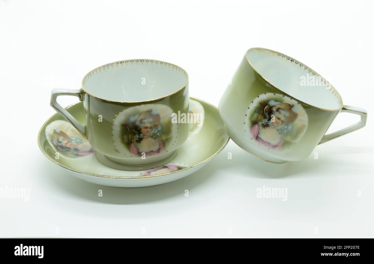An antique and fragile coffee cup and saucer isolated on white background Stock Photo