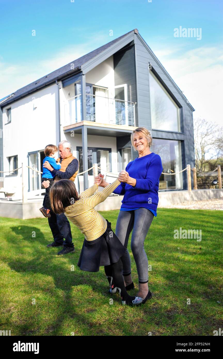 A retired couple spending time with their grandchildren at a holiday apartment in Cornwall England UK. Stock Photo