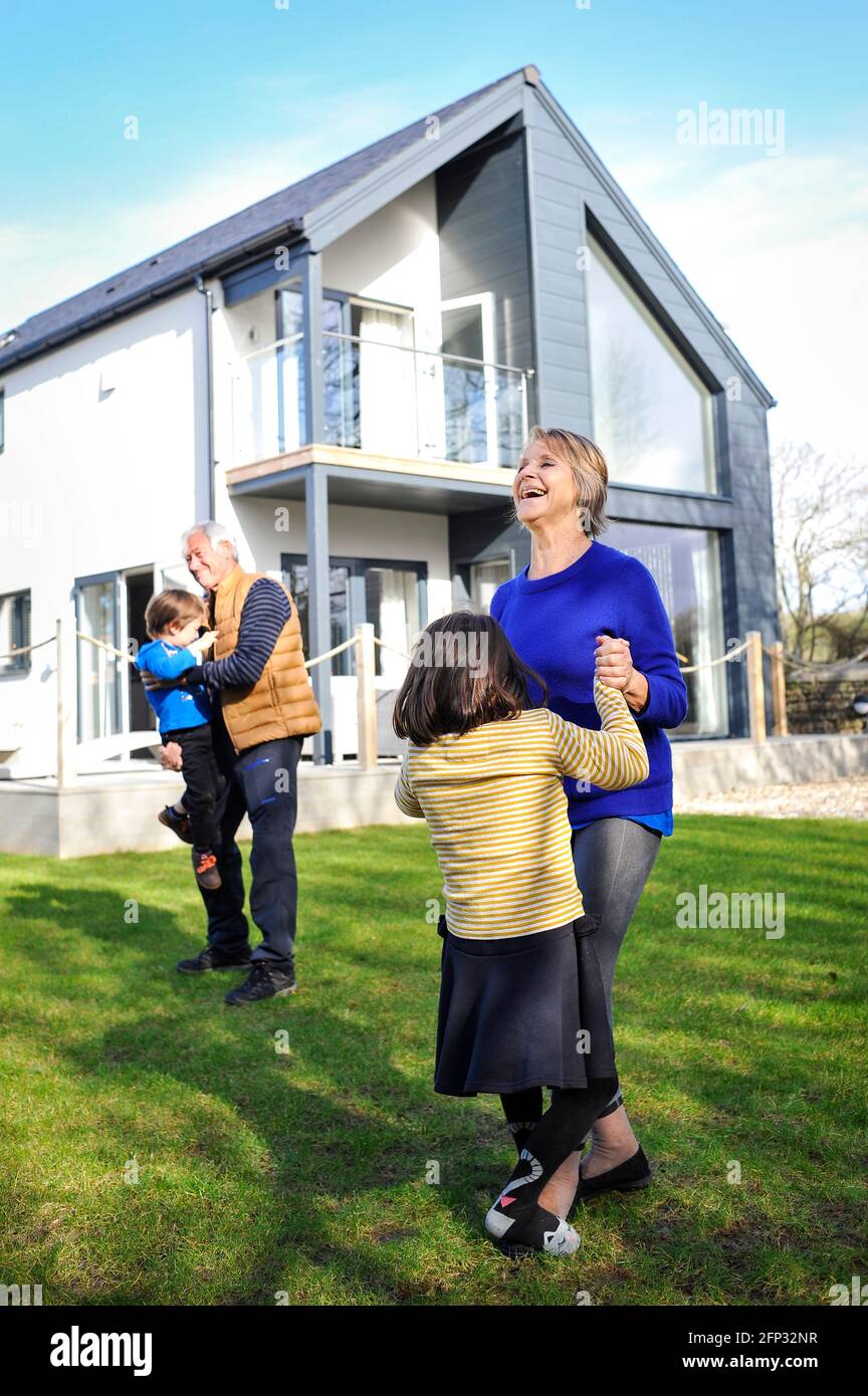 A retired couple spending time with their grandchildren at a holiday apartment in Cornwall England UK. Stock Photo