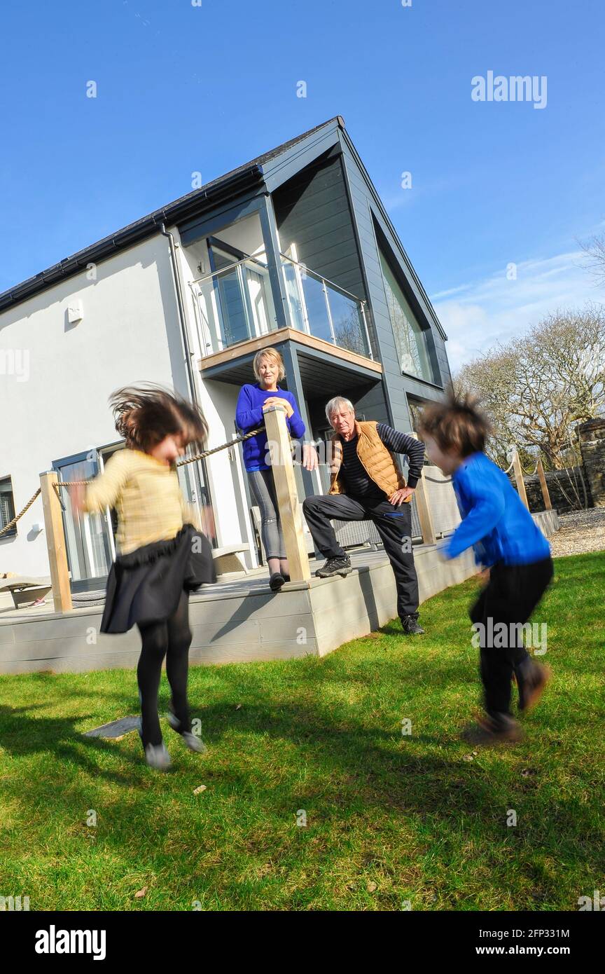 A retired couple spending time with their grandchildren at a holiday apartment in Cornwall England UK. Stock Photo