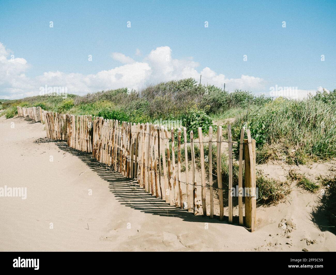 An old wooden fence amongst the sand dunes at Sand Bay, near Weston-super-Mare, in North Somerset Stock Photo