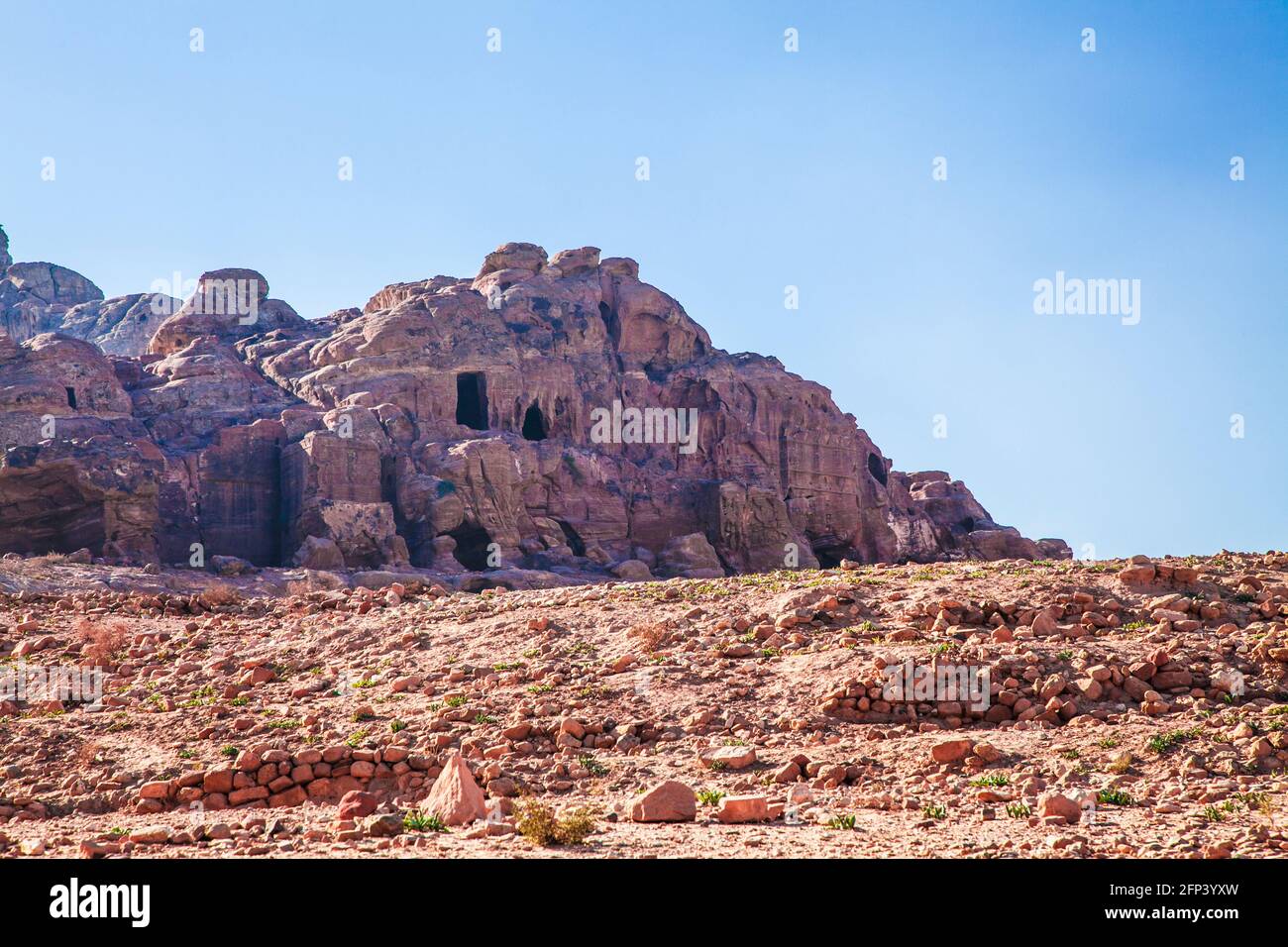 Caves possibly used as tombs or dwellings in Petra, Jordan. Stock Photo
