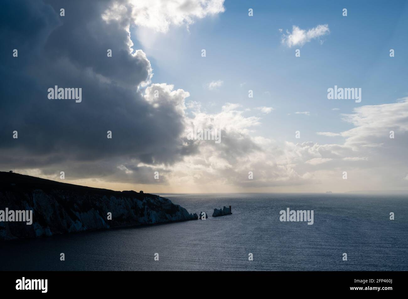 This photo is of The Needles on the tip of The Isle of Wight.The Needles are 3 huge, white chalk rocks, guarded by a 19th-century lighthouse.Located o Stock Photo