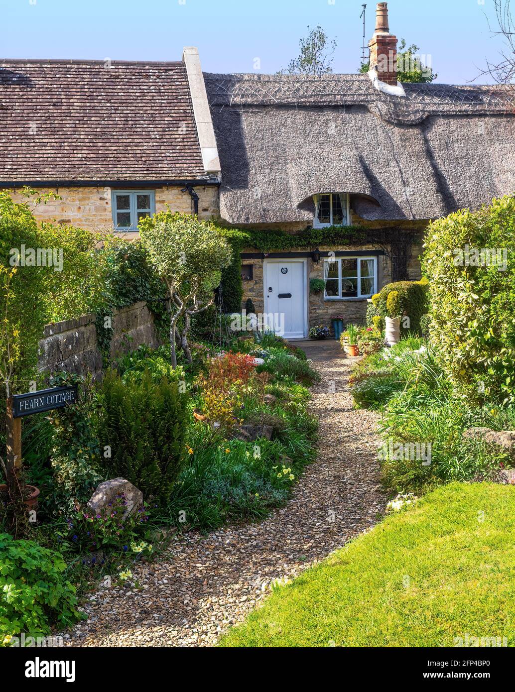 A typical English thatched cottage and country garden. Situated in Edith Weston, a very pretty village on the south shore of Rutland Water. Stock Photo
