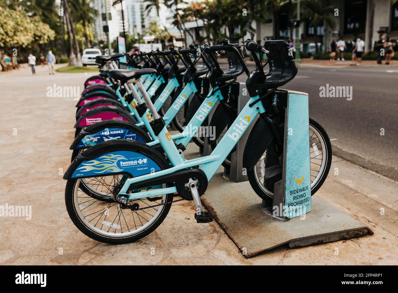 Rental bikes for pedestrians along the street in Waikiki Stock Photo