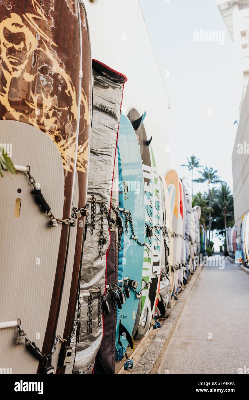Sidewalk lined with surfboards in Waikiki Stock Photo