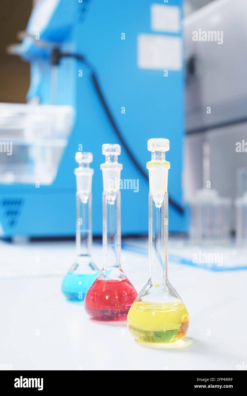 Test tubes and flasks with test liquid on the table in a chemical lab ...