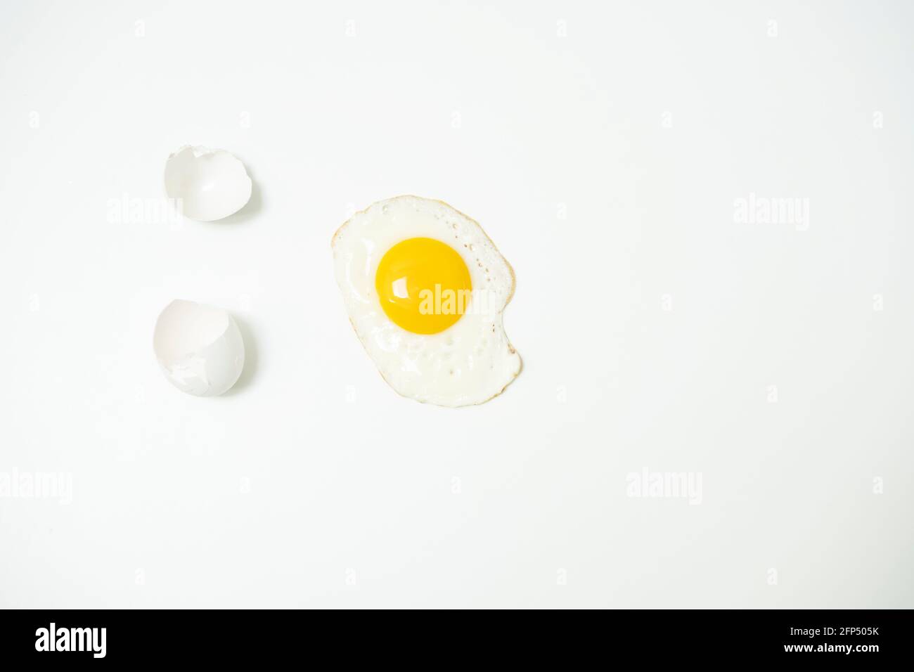 scrambled eggs with whole yolk and broken shells Stock Photo
