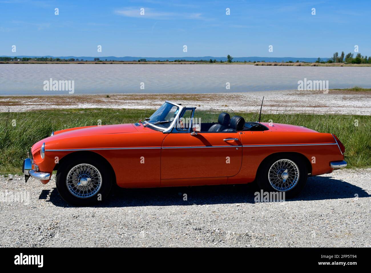 Frauenkirchen, Austria - May 09, 2021: Vintage car MGB on a lake in Neusiedler See - Seewinkel National Park Stock Photo