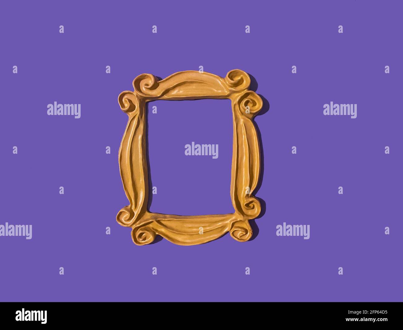 Yellow frame from the FRIENDS tv show which was used around Monica's peephole on the door. Purple wall. Picture frame. FRIENDS television show frame Stock Photo