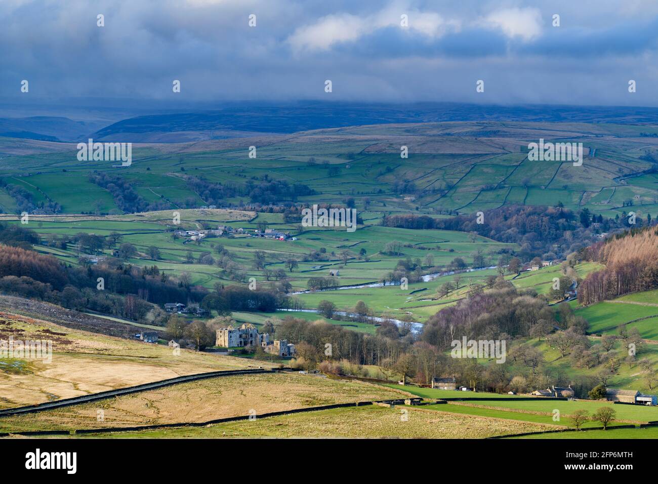 Scenic rural view of Wharfedale (wide green valley, rolling hills, high upland fells & moors, sunlit Barden Tower ruins) - Yorkshire Dales England, UK Stock Photo
