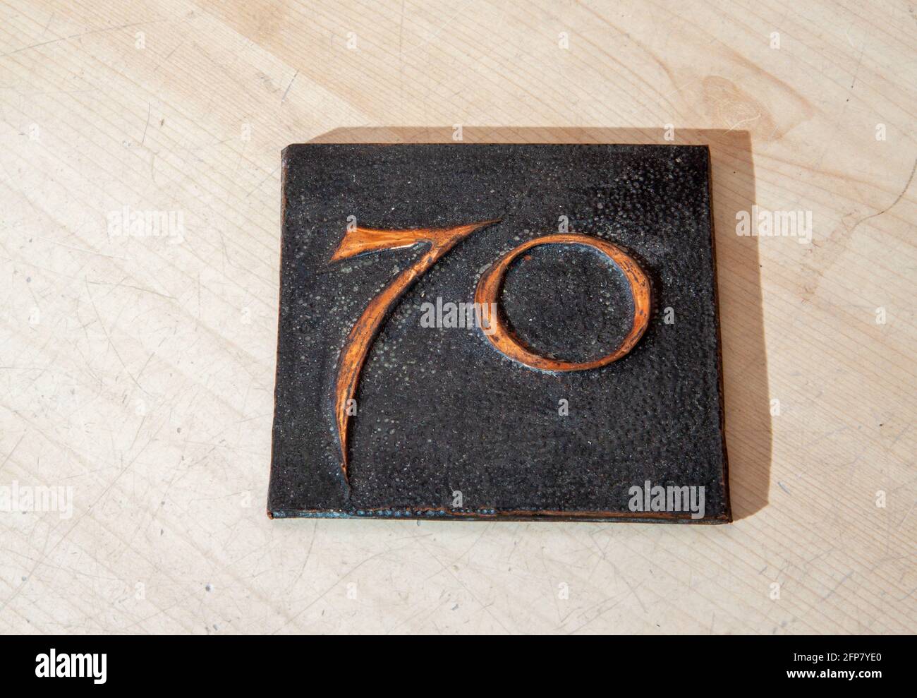 Beaten copper square embossed with the number 70 Stock Photo