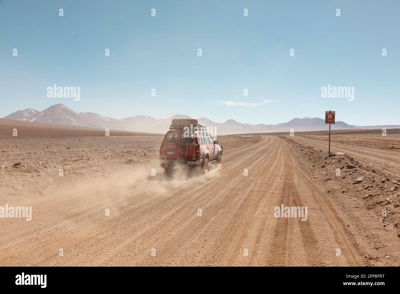4x4 off-road, tourist vehicles driving across the Bolivia's desert landscape on an overland safari. Stock Photo